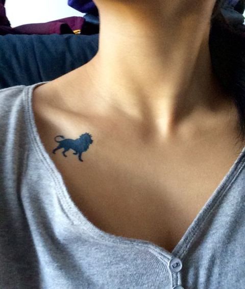 Tiny black tattoo on the collarbone