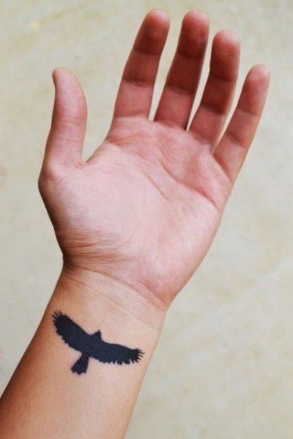 Total black eagle tattoo on the wrist