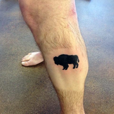 Total black tattoo on the leg