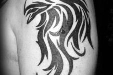 Tribal eagle head tattoo on the arm