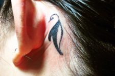 Tribal tattoo behind the ear