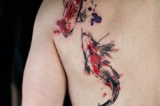 Two fish tattoos on the back and shoulder