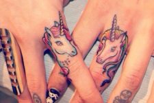 Two unicorn tattoos on the fingers
