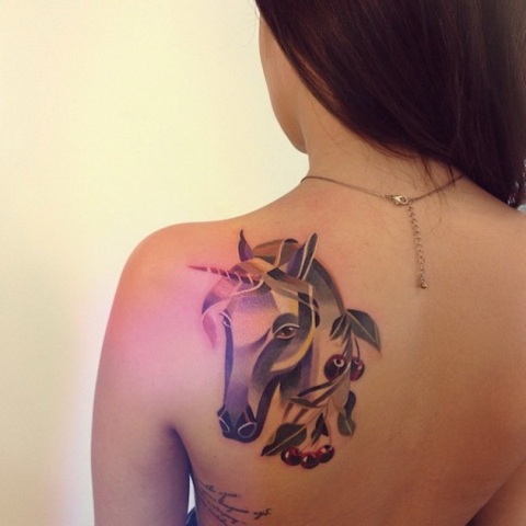 Unicorn and berries tattoo on the back