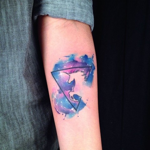 Unicorn and stars tattoo on the arm