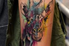 Watercolor giraffe tattoo on the arm