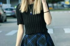 With black sweater and checked skirt