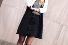 With gray shirt, black skirt, black ankle boots and cardigan