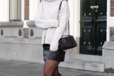 With white sweater, leather skirt and chain strap bag