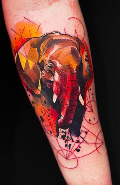 Yellow, red, orange elephant tattoo on the arm