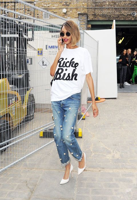 an oversized printed tee, blue cuffed jeans with large pearls and white shoes