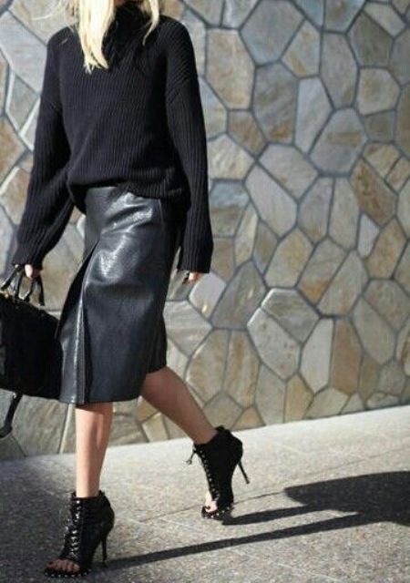 an all-black fall look with a black leather midi skirt, peep toe black leather booties and a black chunky knit sweater