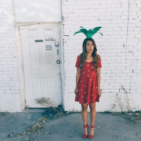 strawberry costume with a red polka dot dress, red ankle strap shoes and a crazy paper hat