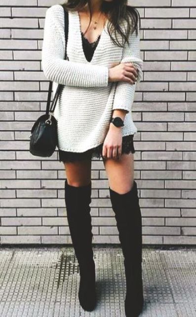 A white deep V neck sweater over a black lace dress, tall black suede boots and a black crossbody