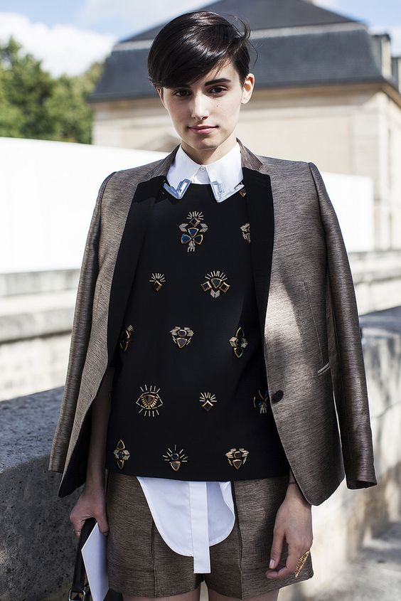 a brown shorts suit, a white shirt, a black embellished sweater for a creative work look