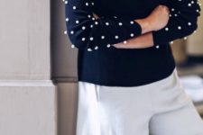 10 a navy sweater contrasts large white pearls on the sleeves and neutral culottes