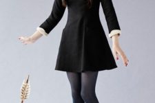 12 Wednesday Addams costume with a little black dress, a white shirt, blue tights and black booties