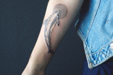 Adorable dolphin tattoo on the forearm