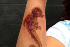 Baby dragon tattoo on the forearm