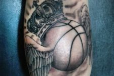 Ball with crown and wings tattoo