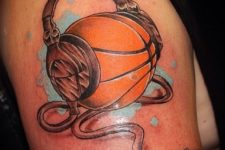 Ball with headphones tattoo