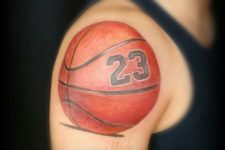 Ball with number tattoo on the shoulder