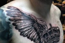 Big crown and wings tattoo