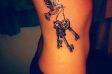 Bird with three keys tattoo on the side