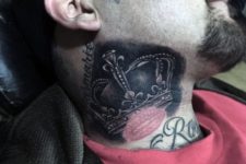 Black and white crown tattoo on the neck