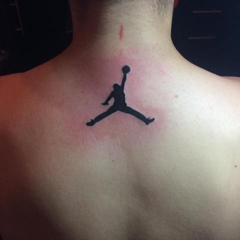 Black colored basketball player tattoo on the neck
