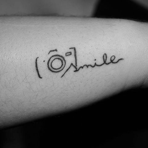Black-contour camera tattoo with word 'smile'