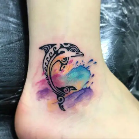 Black dolphin with colorful splashes tattoo
