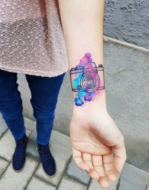 Blue, purple and pink tattoo on the wrist