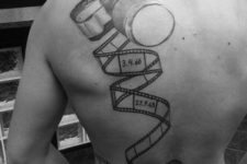Camera and film reel tattoo on the back