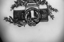 Camera and flowers tattoo on the back