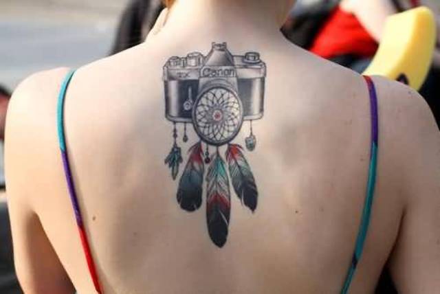Camera with colorful feathers tattoo on the back