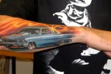 Car and sunset tattoo on the forearm