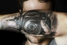 Cool camera tattoo on the forearm