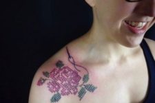 Cross-stitch sewing tattoo on the shoulder
