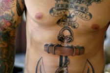 Crown, wings and anchor tattoo on the chest and stomach