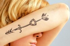 Diamond and arrow tattoo on the forearm