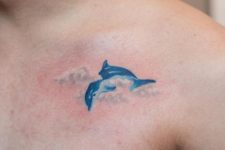 Dolphin and clouds tattoo