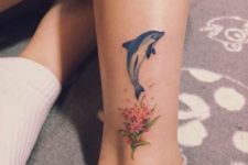 Dolphin and flowers tattoo