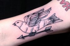 Dove and arrow tattoo on the hand