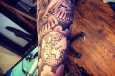 Dove and globe tattoo on the hand