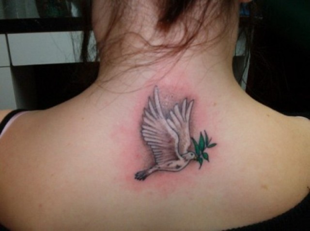 Dove and greenery tattoo on the back