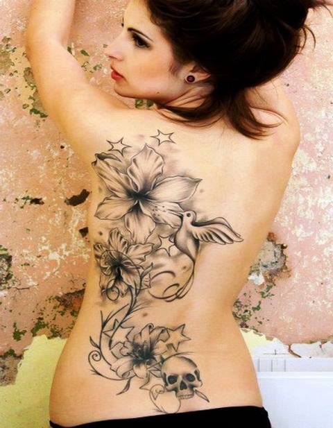 Dove, flowres and skull tattoo on the back