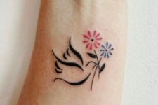 Dove with red and blue flowers tattoo
