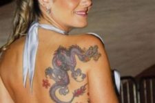 Dragon and red flowers tattoo on the back