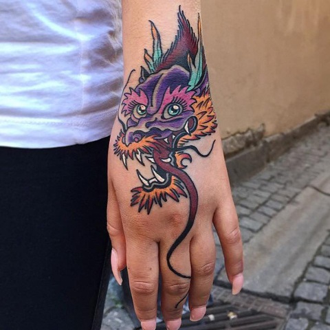 Dragon head tattoo on the hand